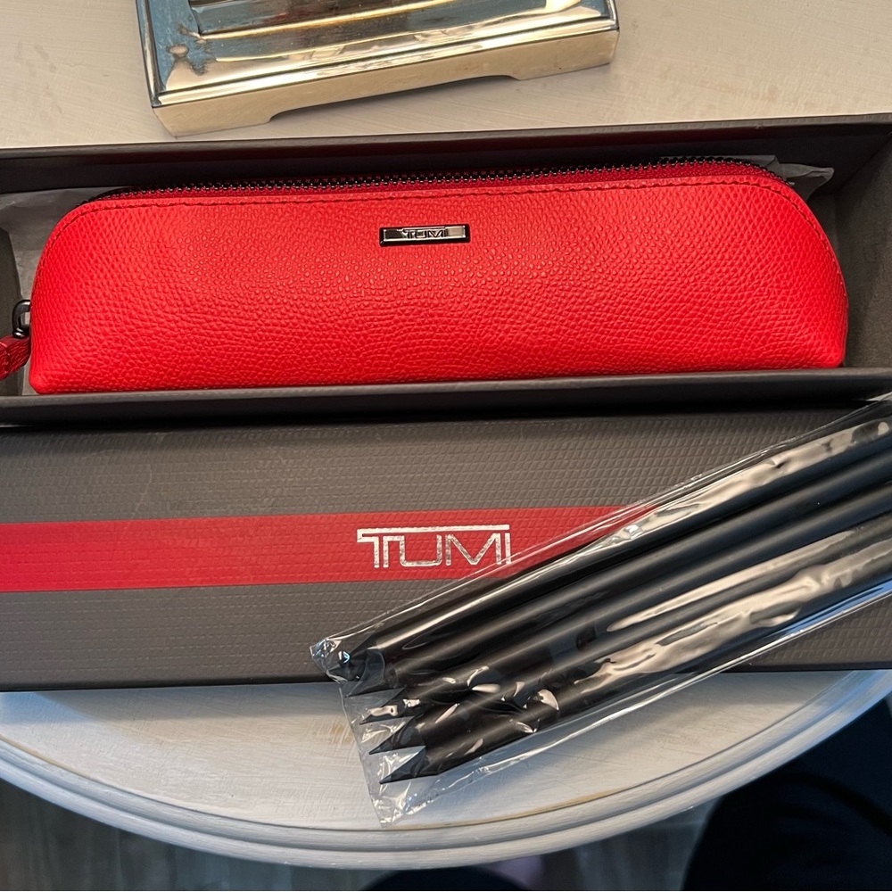 NWOT TUMI red makeup case with pencils.